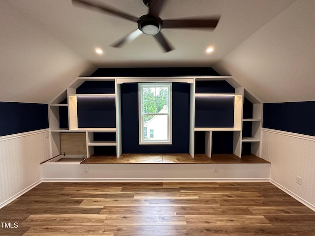 additional living space with hardwood / wood-style floors, ceiling fan, and vaulted ceiling