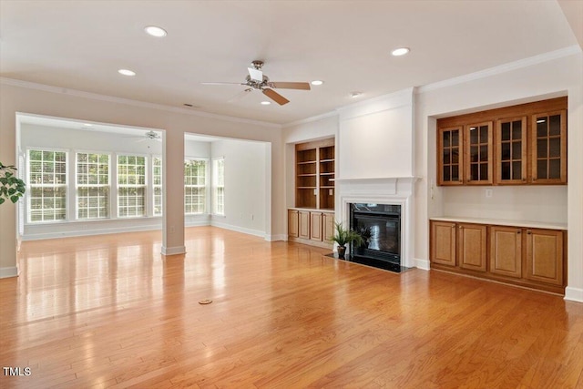 unfurnished living room with recessed lighting, ceiling fan, light wood-style flooring, and a fireplace