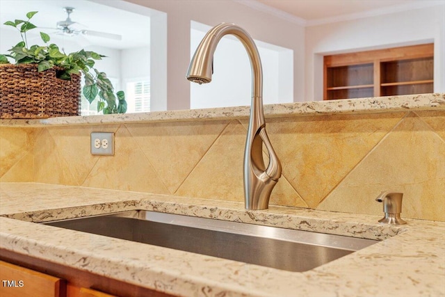 interior details with light stone counters, a sink, and decorative backsplash