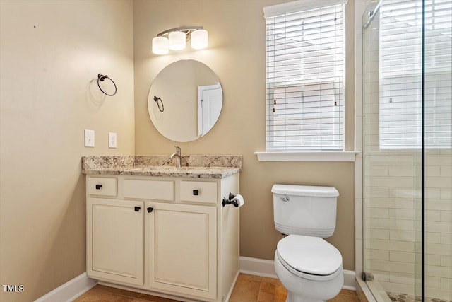 full bath featuring vanity, baseboards, a tile shower, and toilet