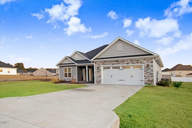 craftsman house with a garage and a front lawn