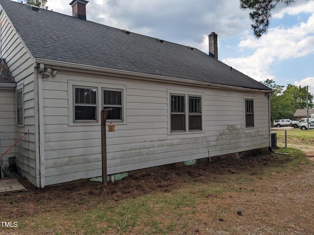 view of home's exterior with a yard and central AC unit