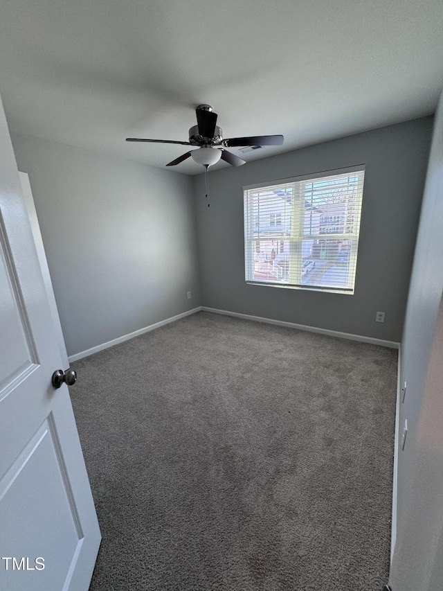 empty room featuring carpet flooring and ceiling fan