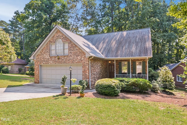 view of front of house featuring a front yard, a garage, and a porch