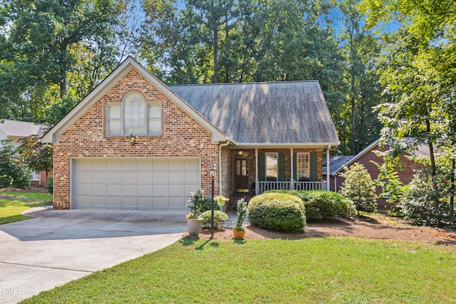 view of front of house featuring a porch, a front lawn, and a garage