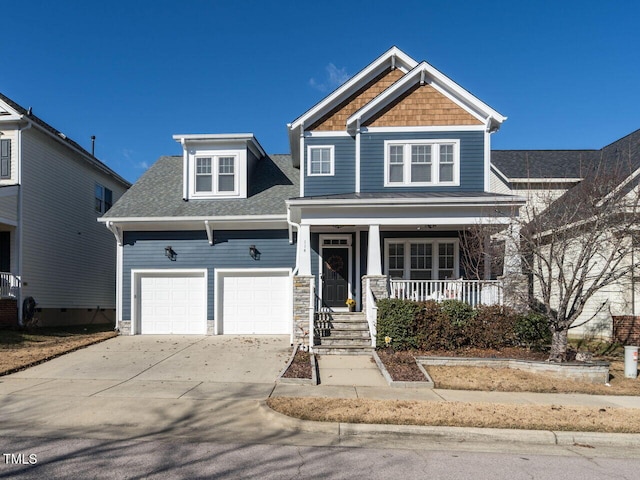 craftsman-style house featuring a porch and a garage