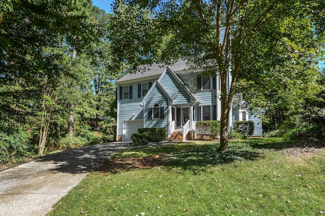 colonial home with a garage and a front lawn