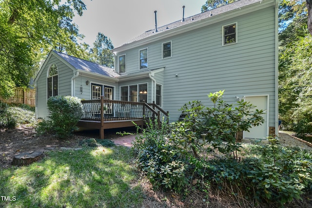 rear view of property featuring a deck