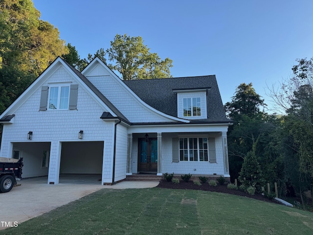 129 Windel Dr, Raleigh, NC 27609 - view of front of house with french doors, an attached garage, a front yard, and concrete driveway