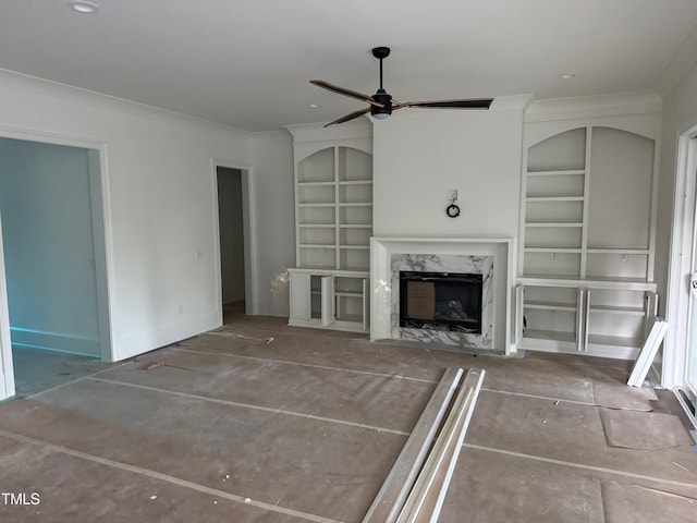 129 Windel Dr, Raleigh, NC 27609 - unfurnished living room with ornamental molding, built in features, a premium fireplace, and ceiling fan