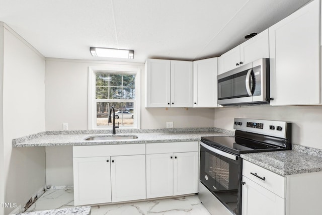 kitchen featuring light stone countertops, sink, white cabinets, and appliances with stainless steel finishes