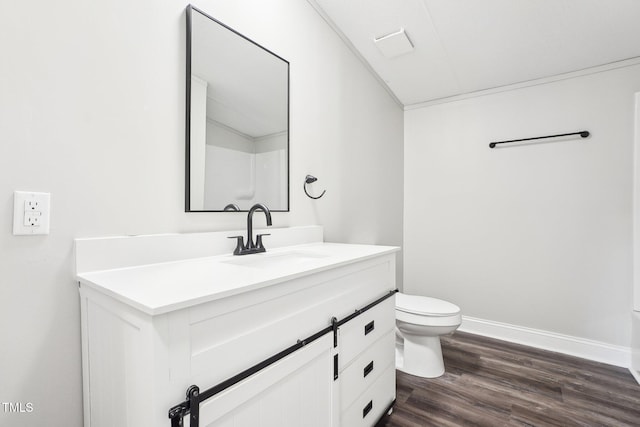 bathroom featuring vanity, hardwood / wood-style flooring, and toilet