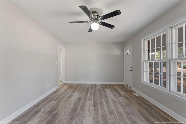 spare room with ceiling fan and wood-type flooring