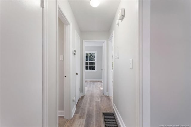 hallway with light hardwood / wood-style flooring