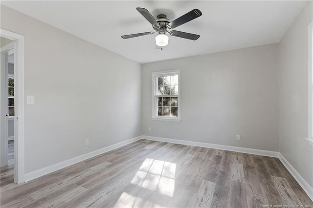 spare room featuring ceiling fan and light hardwood / wood-style flooring