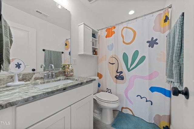 bathroom featuring tile patterned flooring, vanity, and toilet