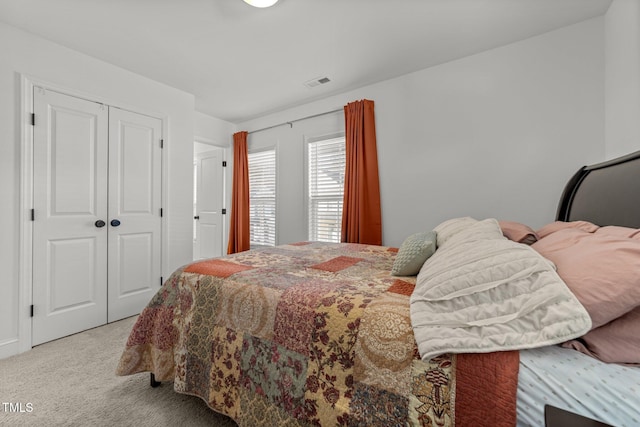 bedroom featuring light carpet and a closet