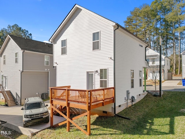 back of house featuring a wooden deck and a yard