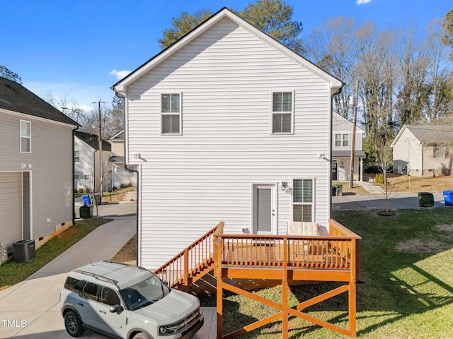 back of house with a yard and a wooden deck