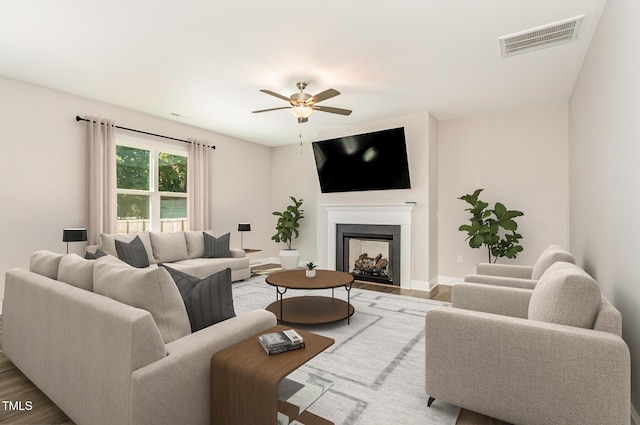 living room featuring ceiling fan and hardwood / wood-style floors