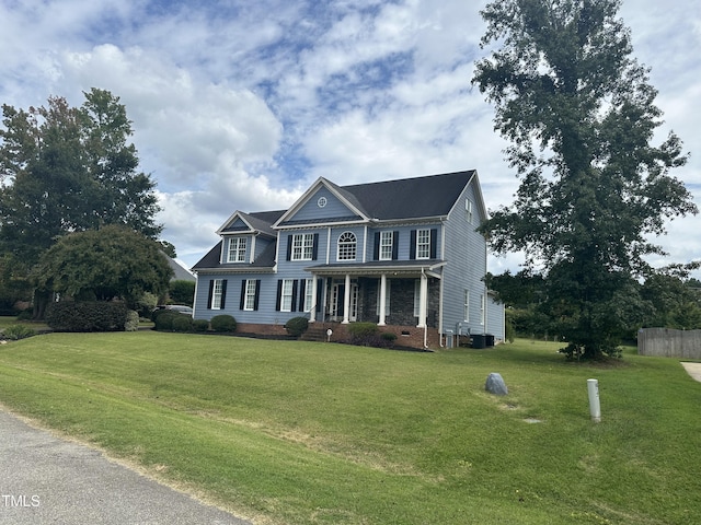 colonial-style house with central AC unit, a porch, and a front yard