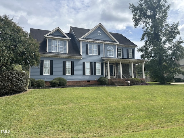 colonial inspired home with a porch and a front lawn