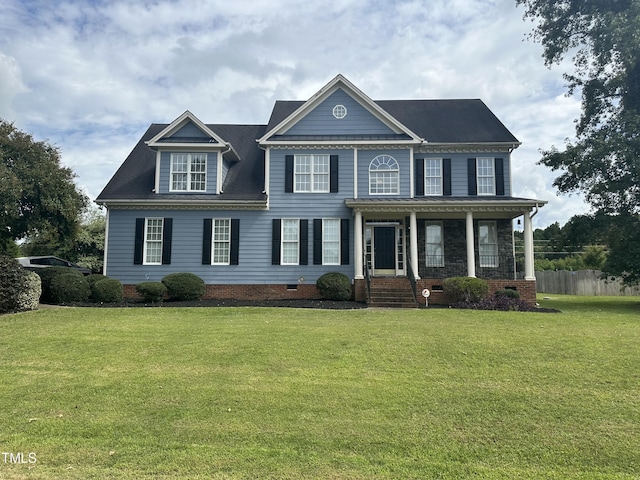 colonial-style house with a front yard and covered porch