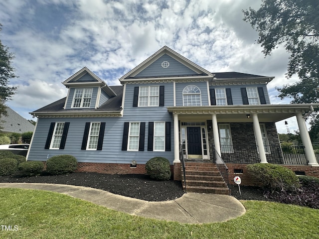 view of front of property featuring a porch and a front lawn