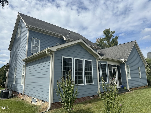 rear view of house featuring a yard and cooling unit