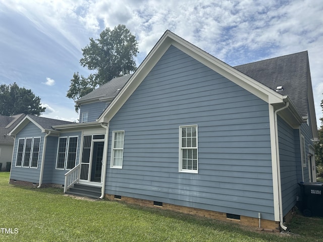 back of house with a lawn