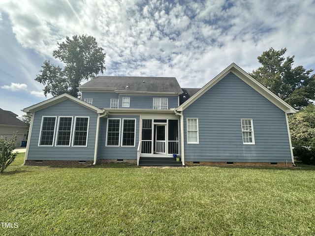 back of house featuring a sunroom and a lawn