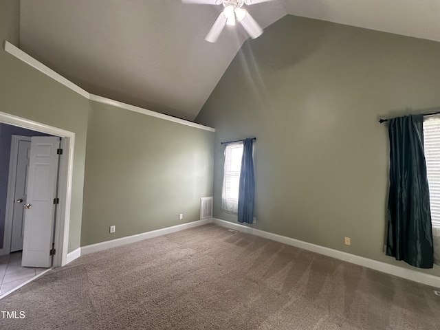 carpeted spare room with high vaulted ceiling and ceiling fan