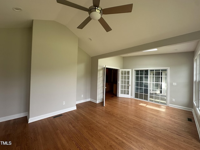 unfurnished room with ceiling fan, wood-type flooring, and vaulted ceiling