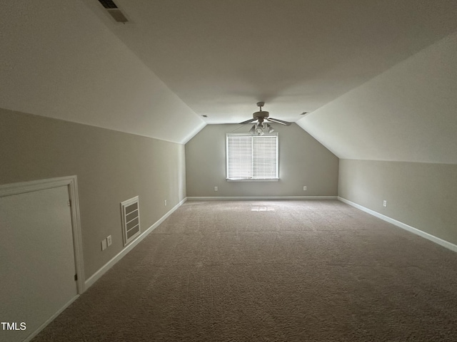 additional living space featuring ceiling fan, carpet floors, and vaulted ceiling