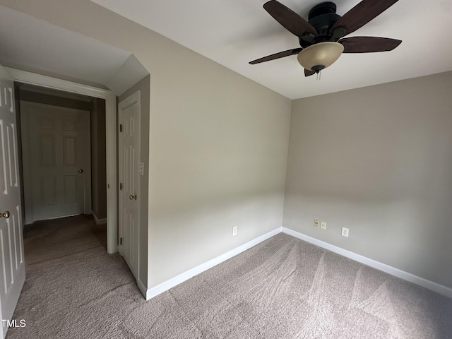 unfurnished room with ceiling fan and light carpet