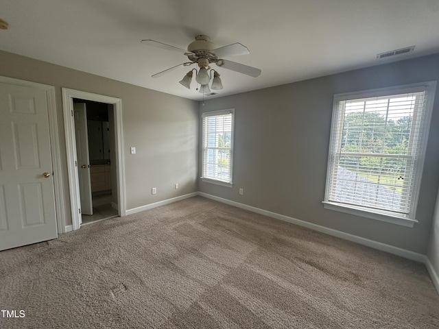 carpeted empty room featuring ceiling fan