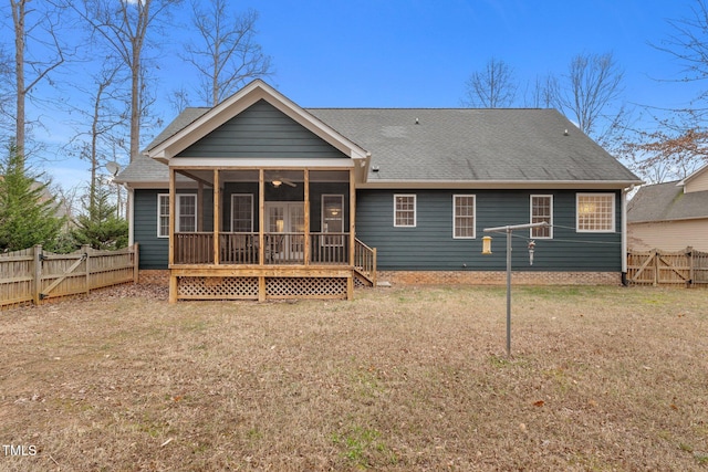 back of house with a lawn and a sunroom