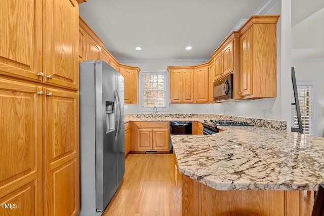 kitchen with black appliances, light wood-type flooring, ornamental molding, light stone counters, and kitchen peninsula