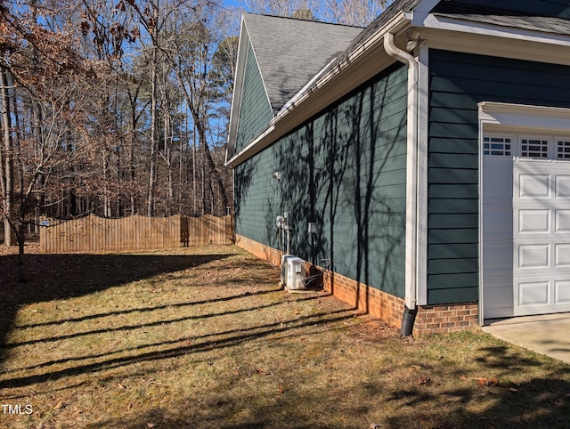 view of side of property featuring a yard and a garage