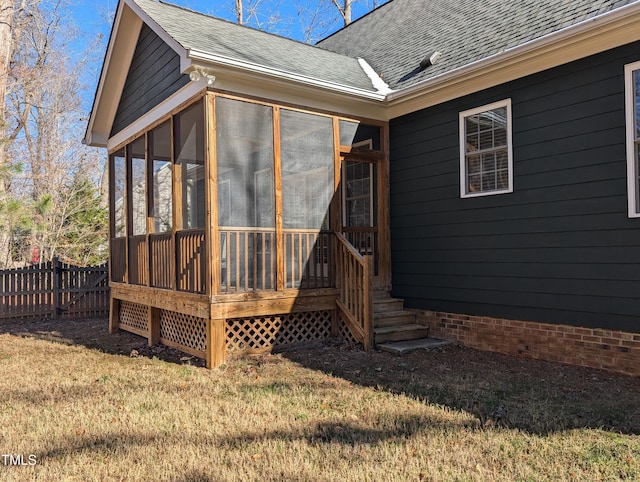 exterior space featuring a lawn and a sunroom