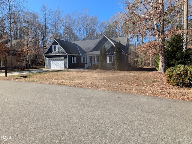 view of front of home with a garage and a front lawn