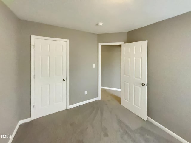 311 Burnette St, Durham, NC 27707 - unfurnished bedroom featuring baseboards and carpet