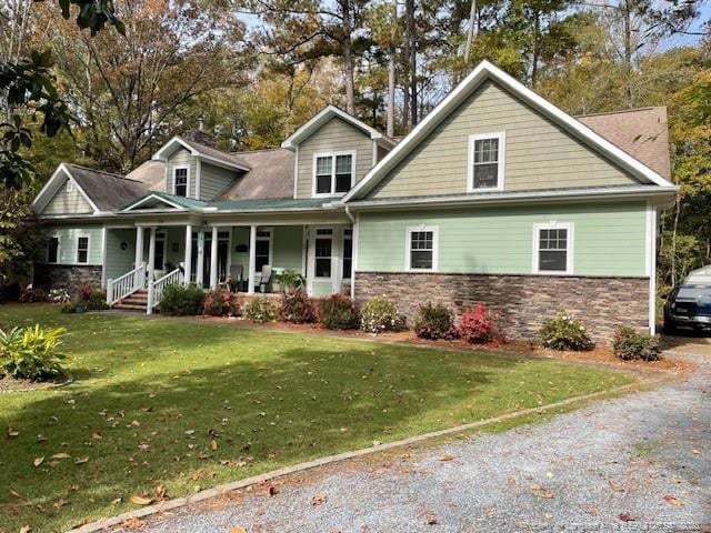 view of front of property with covered porch and a front lawn