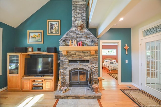 654 Titmouse Ct, Vass, NC 28394 - living area with wood finished floors, vaulted ceiling, and a stone fireplace