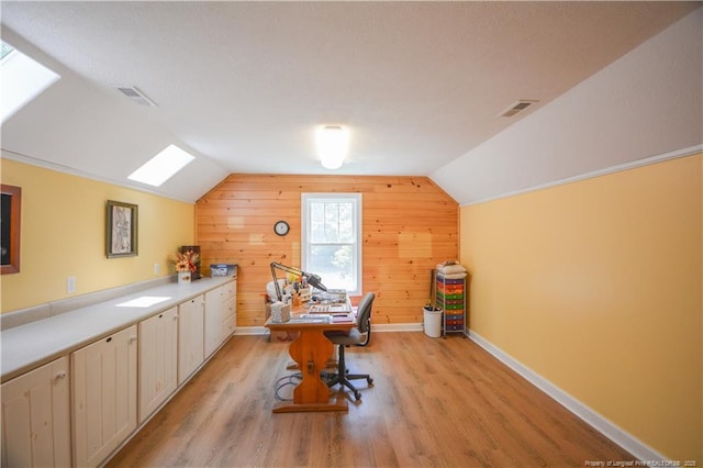 654 Titmouse Ct, Vass, NC 28394 - office area with vaulted ceiling, light wood-style flooring, a skylight, and wood walls
