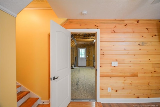 654 Titmouse Ct, Vass, NC 28394 - hallway featuring wood finished floors, ornamental molding, lofted ceiling, and stairway