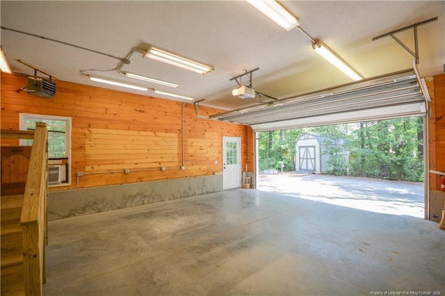 654 Titmouse Ct, Vass, NC 28394 - garage with a shed, a garage door opener, and wood walls