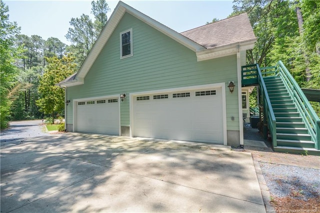 654 Titmouse Ct, Vass, NC 28394 - view of home's exterior featuring stairs, driveway, and a shingled roof