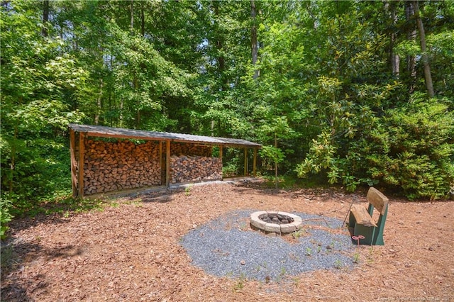 654 Titmouse Ct, Vass, NC 28394 - view of yard featuring a fire pit and a view of trees
