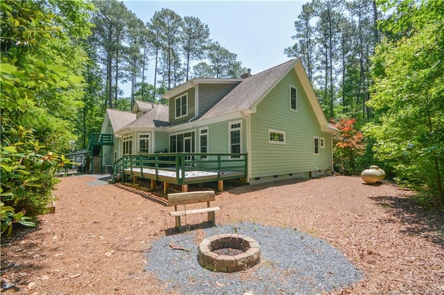 654 Titmouse Ct, Vass, NC 28394 - view of side of property with crawl space, a fire pit, a wooden deck, and roof with shingles